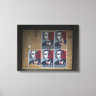 Obama signs in a boarded window of a closed