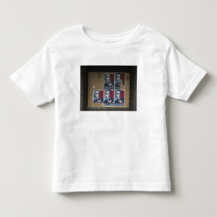 Obama signs in a boarded window of a closed toddler t-shirt