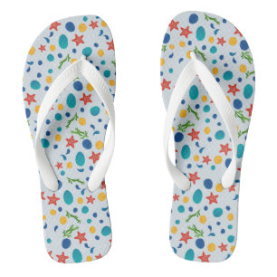 Ocean beach with starfish, shells and pebbles flip flops