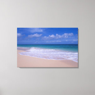 Ocean waves foaming onto sandy beach canvas print