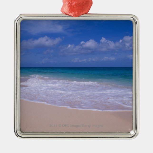 Ocean waves foaming onto sandy beach metal ornament (Front)