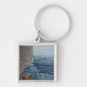 Oceanside seating for two at tiny outdoor cafe, keychain