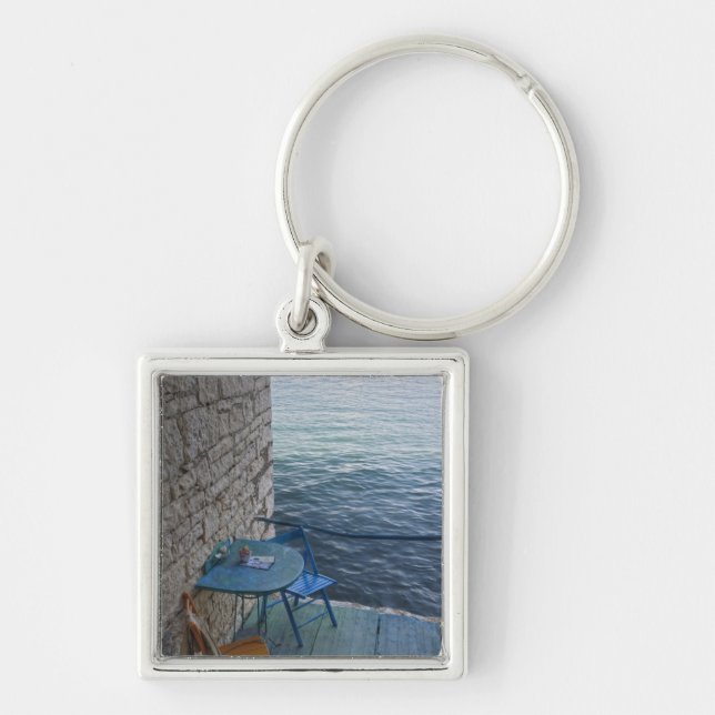 Oceanside seating for two at tiny outdoor cafe, keychain (Front)