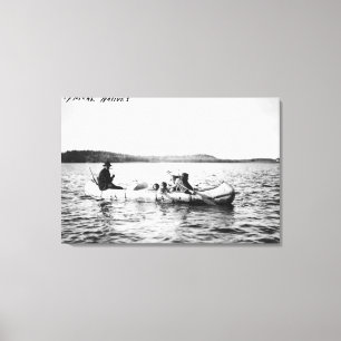 Ojibwa Indians crossing lake in Canoe Photograph Canvas Print