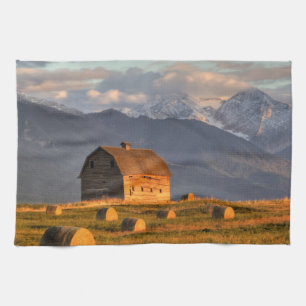 Old barn framed by hay bales and dramatic kitchen towel