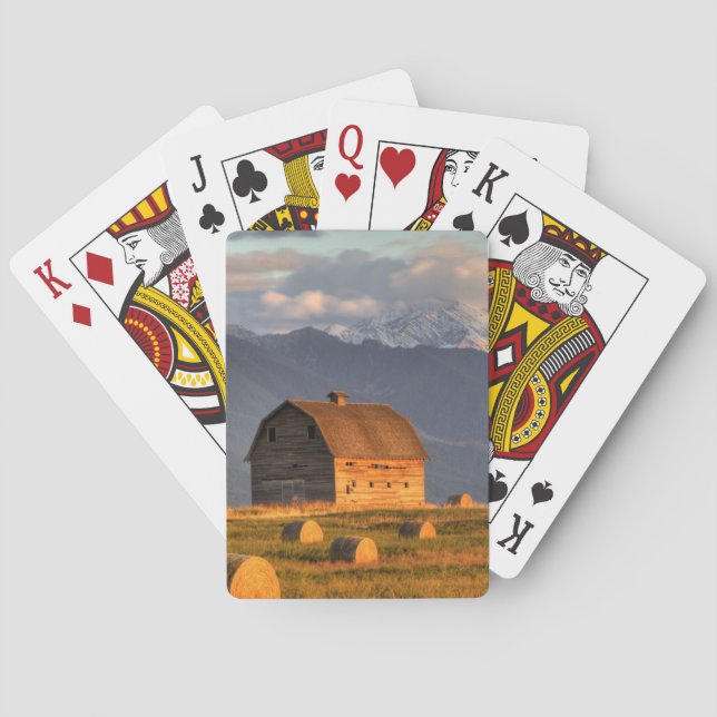 Old barn framed by hay bales and dramatic playing cards (Back)