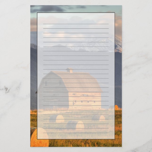 Old barn framed by hay bales and dramatic stationery (Front)