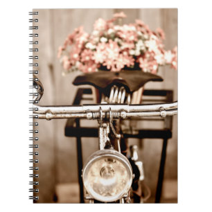 Old bicycle and flowers blur in background process notebook