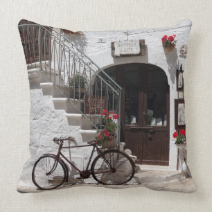 Old bike and storefront in Apulia Throw Pillow