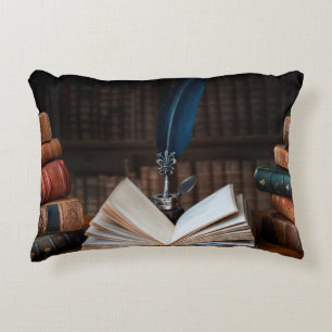 Old books, quill pen and vintage inkwell on wooden accent pillow