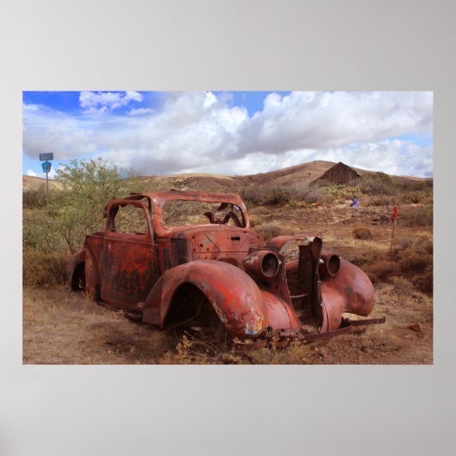 Old Car Rusting In Desert Landscape Poster (Front)