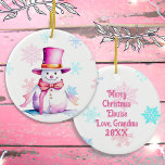 Old-Fashioned Christmas Snowman in Pink  Ceramic Ornament<br><div class="desc">Pretty personalized Christmas ornament with a cute retro snowman in a pink hat surrounded by falling pink and blue snowflakes. The back can be personalized with a custom message.</div>