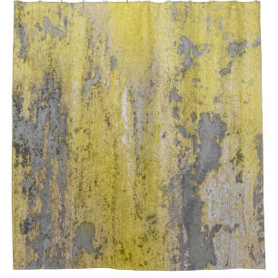 Old grey concrete wall with peeling yellow paint. 