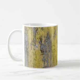 Old grey concrete wall with peeling yellow paint.  coffee mug