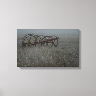Old hay rake farm equipment in the winter frosty canvas print