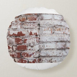 Old painted brick wall with peeling white paintwal round pillow