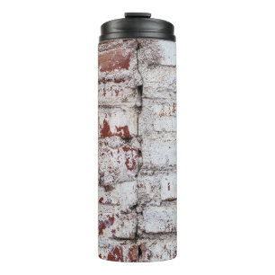Old painted brick wall with peeling white paintwal thermal tumbler