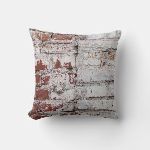 Old painted brick wall with peeling white paintwal throw pillow