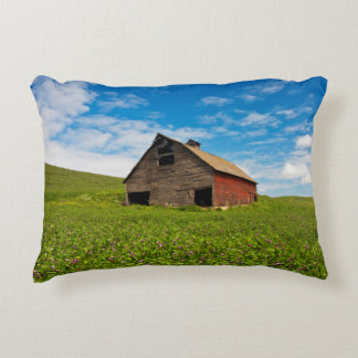 Old, red barn in field of chickpeas decorative pillow