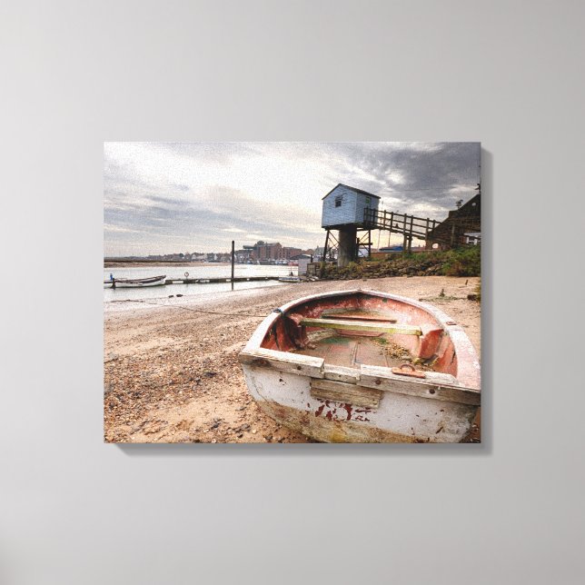 Old red rowing boat on the beach with tower canvas print (Front)