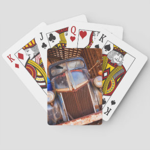 Old rusty truck on a farm playing cards
