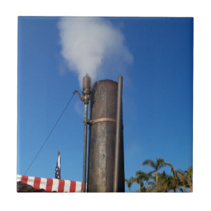 old steam whistle with a white plume of steam tile