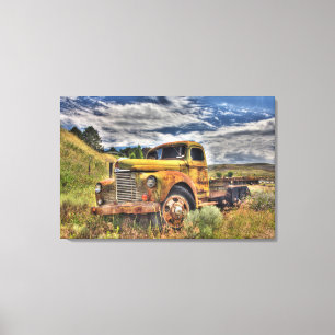 Old truck abandoned in field canvas print