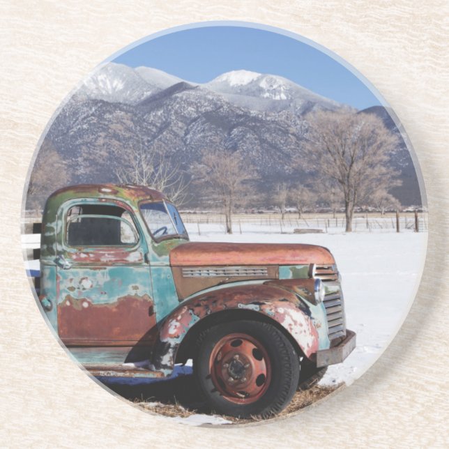 Old truck sitting in the field coaster (Front)