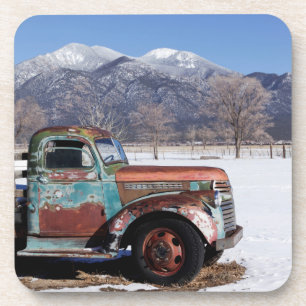 Old truck sitting in the field coaster