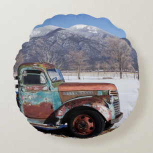 Old truck sitting in the field round pillow