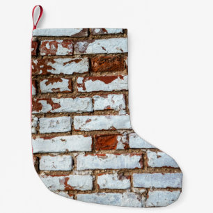 Old vintage brick wall with sprinkled white plaste small christmas stocking