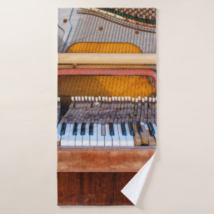 Old vintage piano with the lid off. A dilapidated Bath Towel