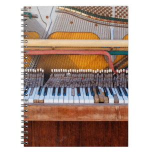 Old vintage piano with the lid off. A dilapidated  Notebook