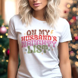 On My Husband's Naughty List Funny Christmas Tri-Blend Shirt<br><div class="desc">Add some playful humour to your holiday wardrobe with this "On My Husband's Naughty List" retro Christmas shirt! Featuring bold, vintage-inspired typography in festive colours and fun star accents, this design is perfect for spreading holiday cheer with a cheeky twist. Ideal for holiday parties, casual outings, or as a humourous...</div>