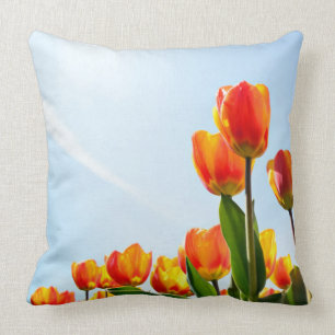Orange and red tulips from below throw pillow