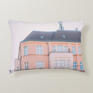 ORANGE AND WHITE CONCRETE BUILDING ACCENT PILLOW