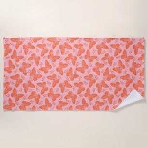 Orange butterfly pattern on pink background beach towel
