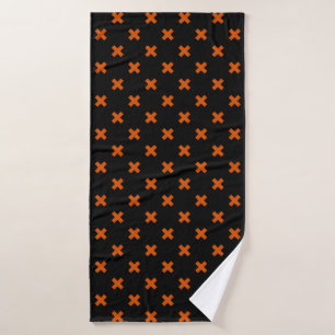 Orange cross stitches on black bath towel