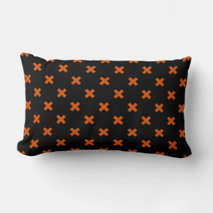 Orange cross stitches on black lumbar pillow