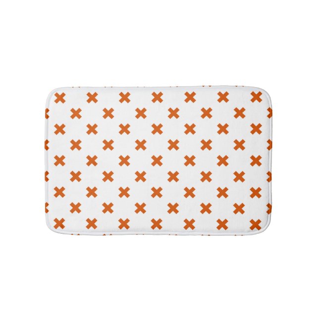 Orange cross stitches on white bath mat (Front)