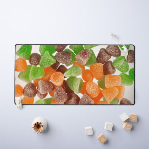 Orange green red gum candy sprinkled with sugar desk mat