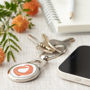 Orange heart dragon on white keychain