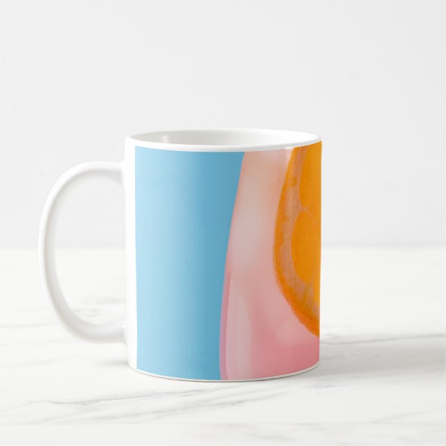 Orange juice in clear drinking glass coffee mug (Left)