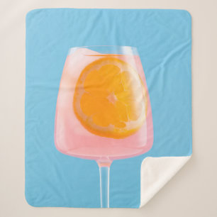 Orange juice in clear drinking glass sherpa blanket