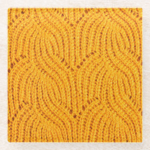 Orange knitted sweater, textured background. glass coaster