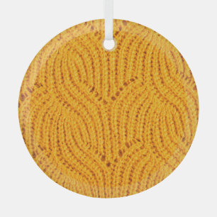 Orange knitted sweater, textured background. glass ornament