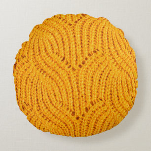 Orange knitted sweater, textured background. round pillow