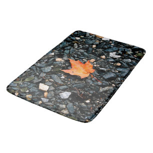 Orange Leaf on Black Rocks Bath Mat