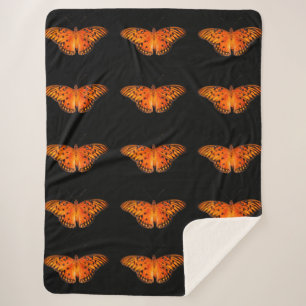 Orange passion butterflies on dark sherpa blanket