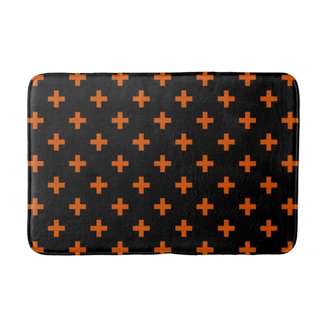 Orange polka crosses on black bath mat (Front)